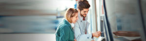 Young adult coupled getting money from an ATM machine