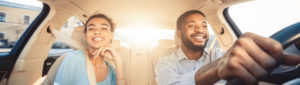 African american couple smiling and going for a car ride in their new car