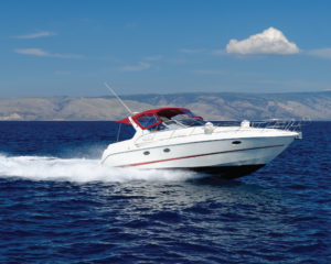 Luxury speedboat traveling over dark blue water leaving a white trail of water behind