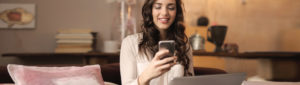 Young woman looking at smartphone and smiling