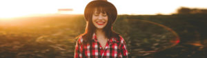 Young female adult smiling in field